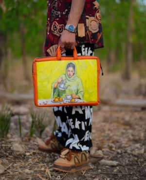Leather laptop bag featuring a Moroccan woman at a traditional dining table